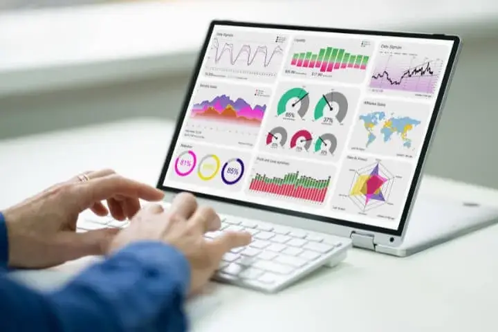 A data analyst using a computer to track the development of a crisis monitoring in real-time